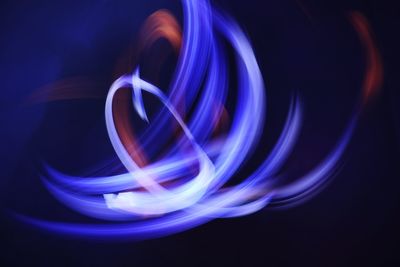 Close-up of light painting against black background