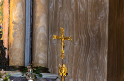 Cross sculpture in temple outside building