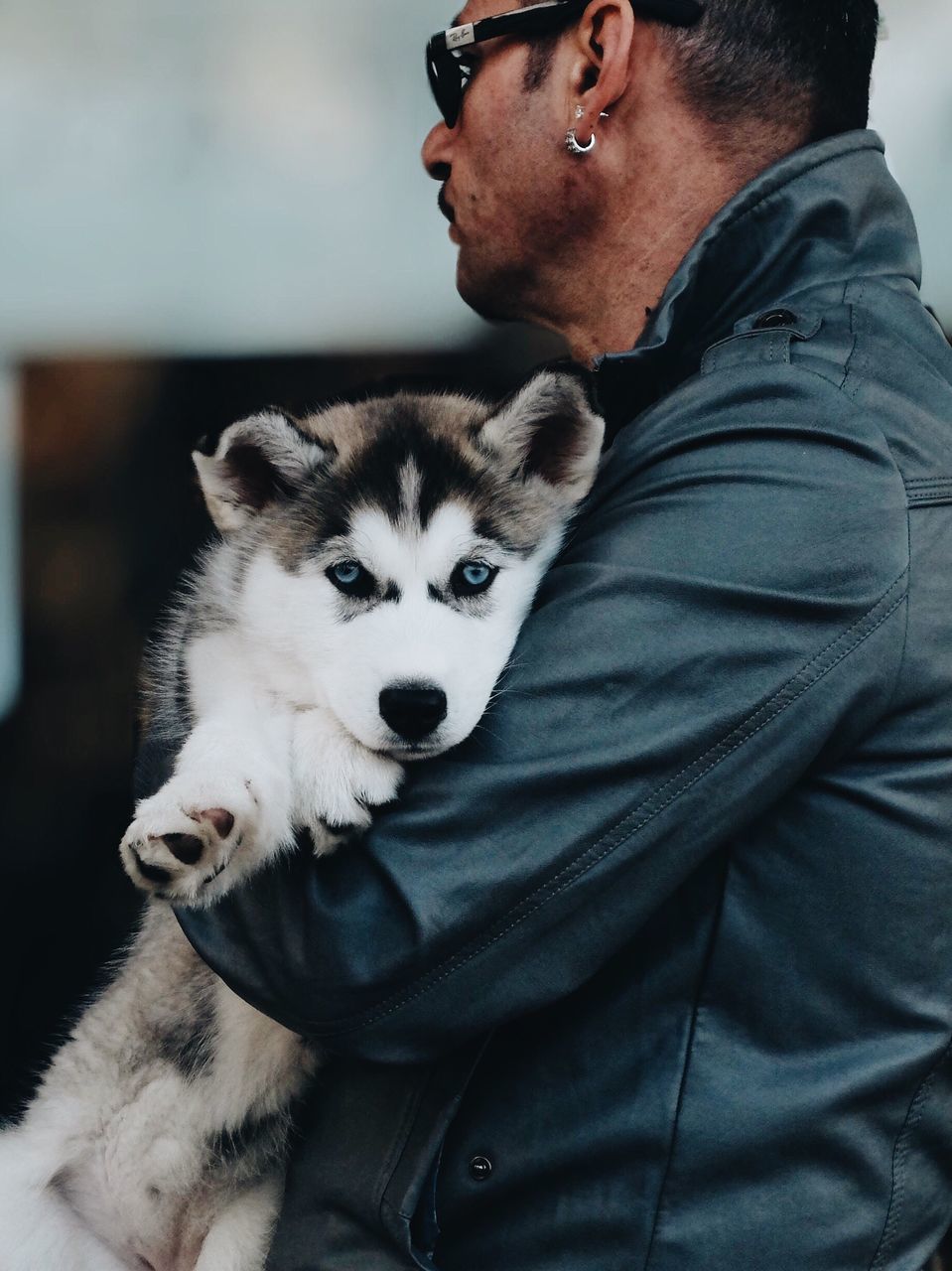 pets, one animal, animal themes, domestic animals, mammal, dog, looking at camera, portrait, lifestyles, pet owner, leisure activity, men, front view, holding, focus on foreground, young men, casual clothing