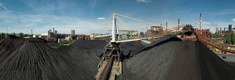 Panoramic view of coal mine against sky