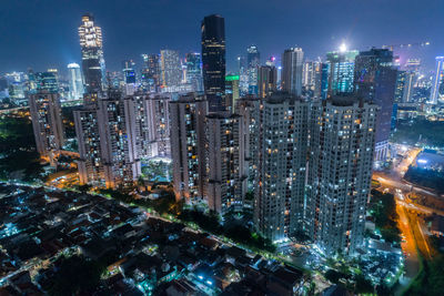 Aerial view of illuminated buildings in city at night