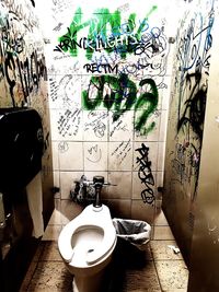 Graffiti on wall in bathroom