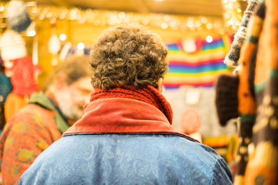 Rear view of couple sitting outdoors