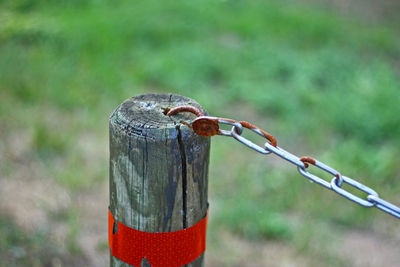 Close-up of rusty chain and post