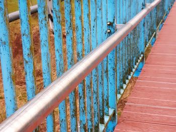 Metal fence against blue wall