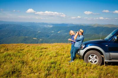 Man on landscape against mountain range