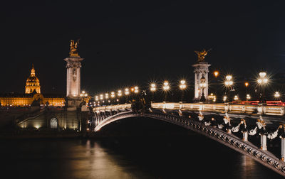 Illuminated bridge at night