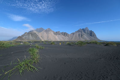 Scenic view of mountains against blue sky