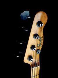 Close-up of guitar against black background