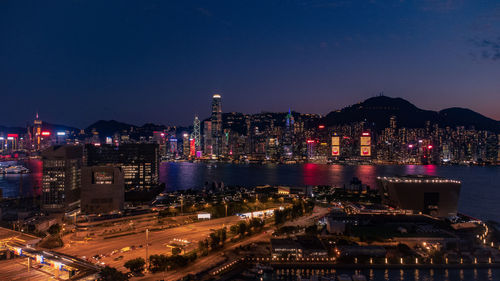 Illuminated cityscape against sky at night high rise across the victoria harbour