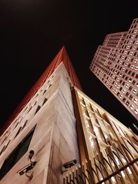 Low angle view of illuminated building against sky at night