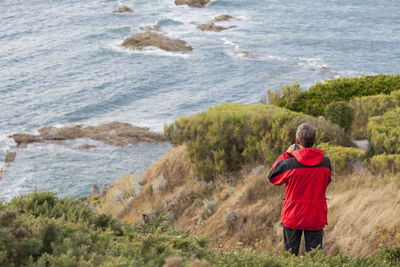 Rear view of man standing on beach