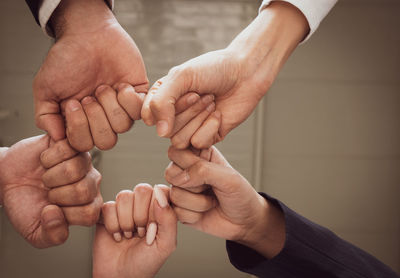 Midsection of man holding hands