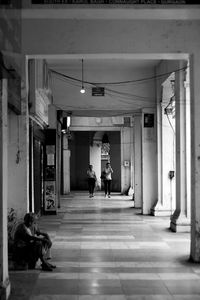 People walking in corridor of building