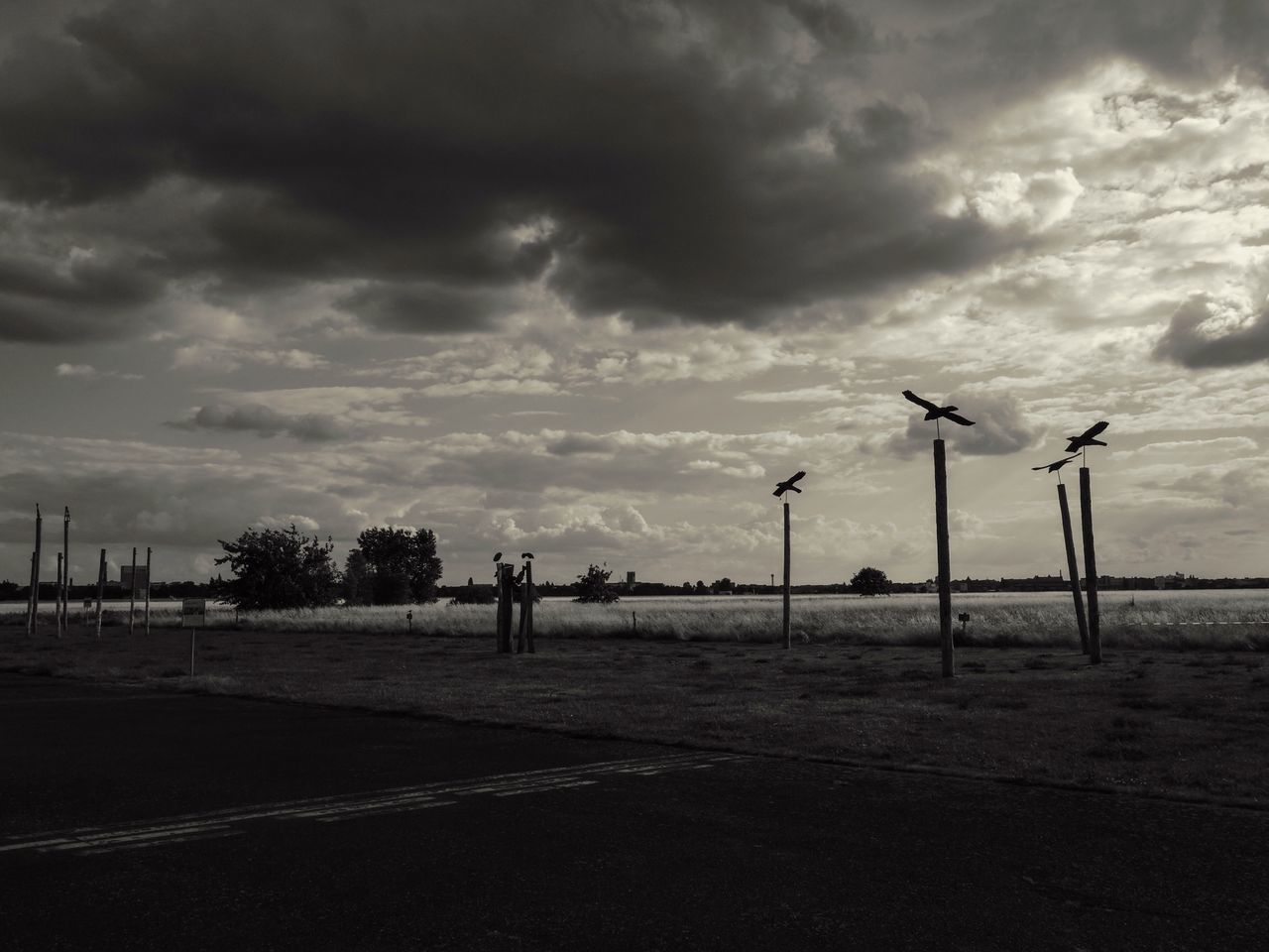 sky, cloud - sky, cloudy, street light, cloud, tranquility, weather, tranquil scene, nature, overcast, beach, transportation, silhouette, scenics, road, sea, outdoors, incidental people, beauty in nature, day