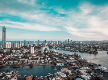 High angle view of bay and buildings against sky