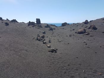 Scenic view of beach against clear sky