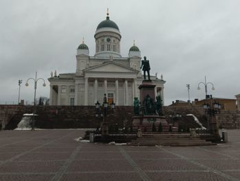 Statue of cathedral against cloudy sky