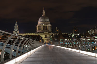 View of illuminated cathedral against sky in city