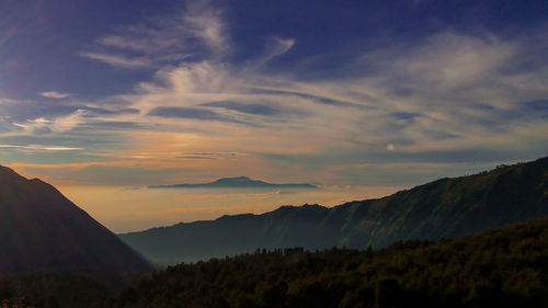 Scenic view of mountains against sky at sunset