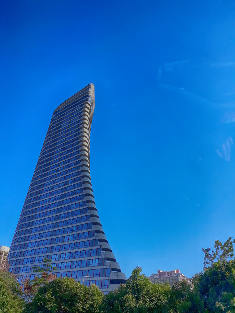 sky, built structure, architecture, blue, building exterior, low angle view, nature, plant, day, no people, building, tall - high, tree, office building exterior, modern, tower, outdoors, skyscraper, city, clear sky