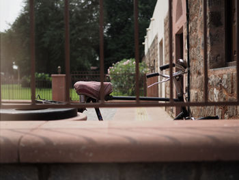 Close-up of chair on table against building