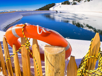 An orange lifesaver of a water reservoir for snow production in the italian dolomites