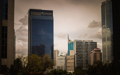 Low angle view of skyscrapers against sky during sunset