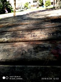 Close-up of text on wooden wall by building