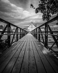 Surface level of footbridge on footpath against sky