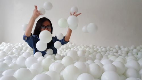 Portrait of boy with balloons in container