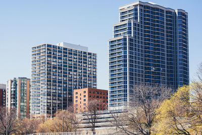 Low angle view of skyscrapers against clear sky