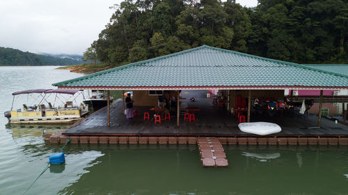 People in swimming pool by lake