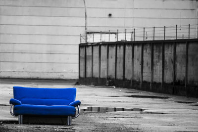 Empty bench against wall