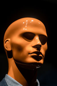 Close-up of mask against black background
