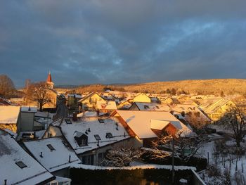 High angle view of houses in town against sky