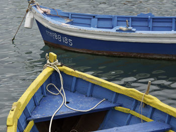 Rope tied to boat moored in sea