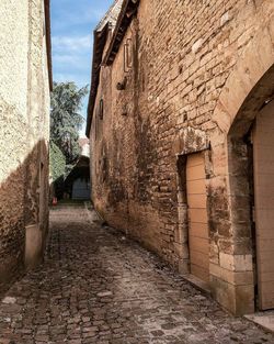 Alley amidst buildings against sky