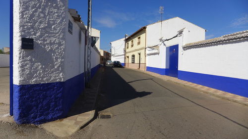 Street amidst buildings against sky