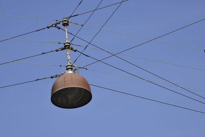 Low angle view of cables against clear blue sky