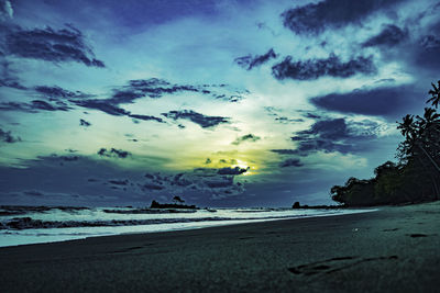 Scenic view of beach against sky during sunset