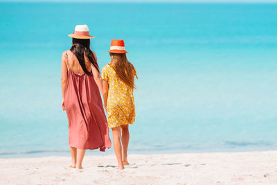 Rear view of woman walking on beach