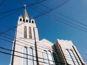 Low angle view of buildings against clear blue sky