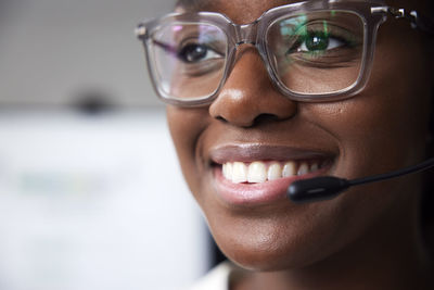 Smiling young woman working in call center