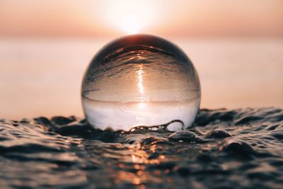 Close-up of crystal ball on shore