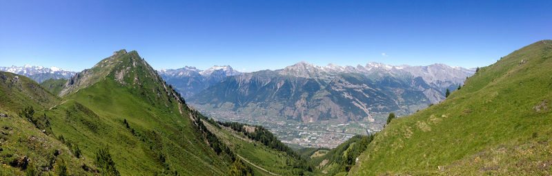 Scenic view of mountains against blue sky