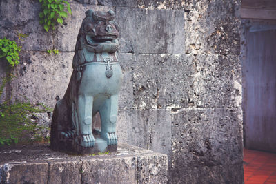 Statue against wall