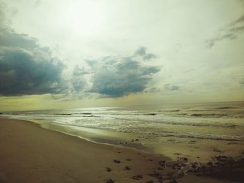 Scenic view of beach against sky during sunset