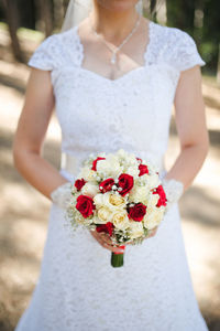 Midsection of person holding bouquet