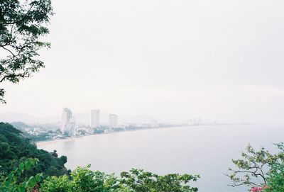 Scenic view of lake by buildings against sky